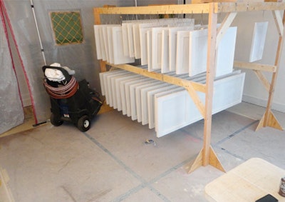 Once the floors were wrapped and protected, the master bedroom became a spray booth for cabinetry and trim items.