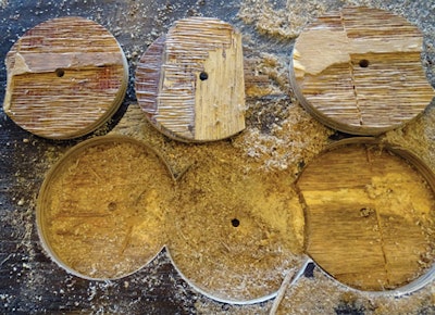 Wood fibers can clearly be seen attached to the adjoining layers of these pucks cut with a hole saw. The failure was caused by wood shear, not delamination.