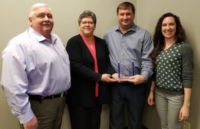 Fishman Flooring Solutions President and CEO Bob Wagner (left) celebrated the recognition with Fishman team members Mary Henritz (holding the award), Shane Richmond and Stephanie Moliterno.