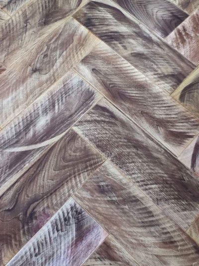 This A&H Fine Finishing walnut herringbone floor features re-applied circle-sawn marks; the floor is wire-brushed a prefinished with hardwax finish.