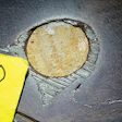 Underneath lighter-looking areas of filler, these round poker-chip-like wood pieces were embedded in the prefinished wood flooring.