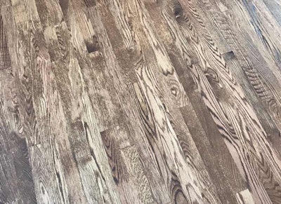 Wood floors that are stained after water-popping but before the wood has had a chance to completely dry can take on a blotchy look like the appearance of this floor.