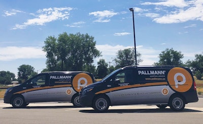 Two of Pallmann's new vans stationed in front of the company's headquarters in Aurora, Colo.