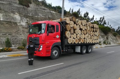 A law enforcement official stops a truck loaded with timber at a checkpoint in Ecuador as part of Interpol's Operation Thunderstorm.