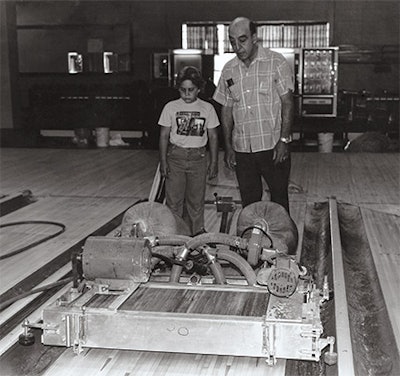 That's me with my grandpa running his G&G Mini Sander invention for bowling lanes; it was a 42-inch-wide belt sander that followed sanding by his G&G Maxi Sander and prepped the lane for finish coats.