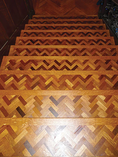 Looking down the grand staircase at the walnut/oak herringbone stair treads.