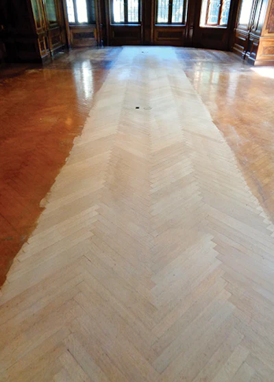 The dining room floor after the center section was cleared of original coatings.