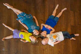 The Walsh's children on the family's new hardwood floor.