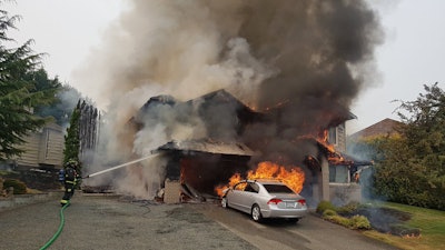 A fire believed to have been ignited from oil-stained rags engulfs a Campbell River home. Source: Campbell River Fire Twitter.