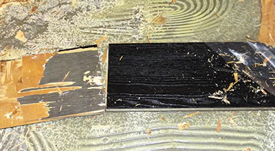 Planks discovered in the dumpster showed adhesive had pushed up into the tongue and groove on both ends and sides.