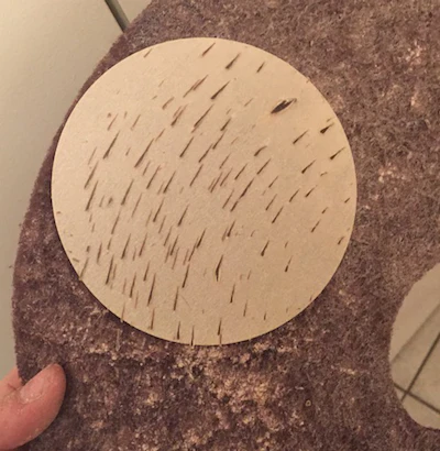 This abrasive is gumming up due to insufficient dry time of the two-component water-based finish.
