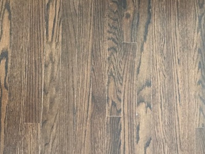 The stain on this floor was not completely dry when it was top-coated with a two-component water-based finish.