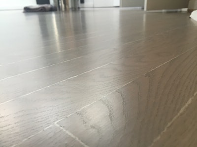 What looks like white lines on this floor is peeling of the two-component water-based finish due to insufficient stain dry time.