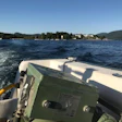 CB Hardwood Flooring transports its Hummel to Recluse Island for a sand and finish job. In the background is The Sagamore, the famous island resort.
