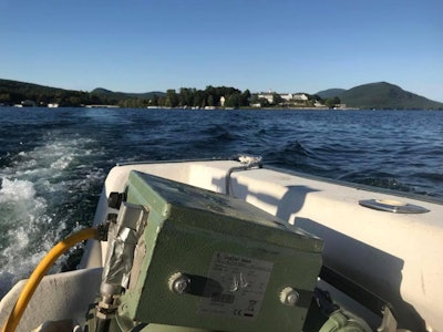 CB Hardwood Flooring transports its Hummel to Recluse Island for a sand and finish job. In the background is The Sagamore, the famous island resort.