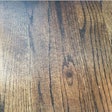 Sanding marks from a hand-held random orbital sander were obvious on this wood floor once stain was applied.
