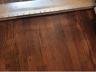 When staining, you have to think about how to blend the abrasive patterns in the field with the edges of your wood floor.