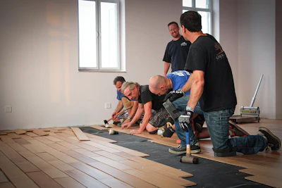 A team assembled by Real Wood Floors installs wood flooring at Shepherd's Field Children's Village in China in 2014. (Click the image to read the full story)
