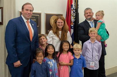 U.S. Rep. Jason Smith (left) stands with the Cobb family after Rachel and Sam were recognized for their charity work with adoption agencies.