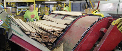 (3) An automatic tilt-hoist down-stacks boards onto the side-match conveyor.