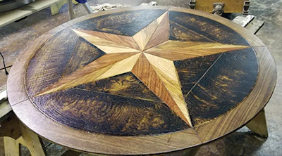 This Texas star medallion used the homeowner's local mesquite and pecan with a walnut frame and shou sugi ban curly white oak for an accent between the star points.