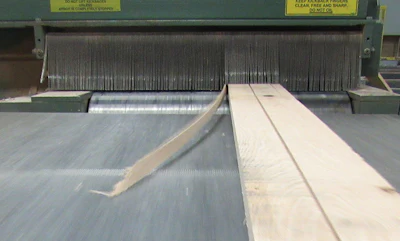 (2) A board exits the gang-rip saw.
