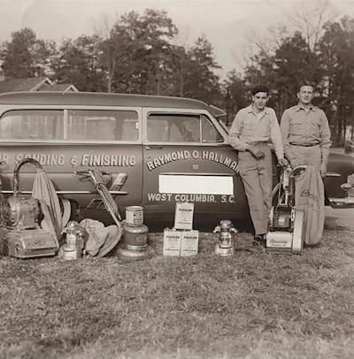 Raymond Hallman (right) started working on wood floors when he was 10 years old. He founded Columbia Flooring Inc. in West Columbia, S.C., in 1953.