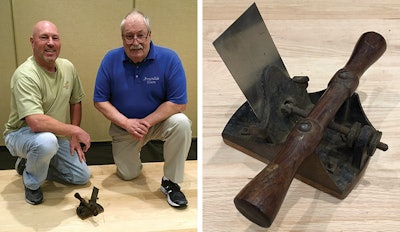 Vance Hough (at right) and his nephew, Walter Cornwell, with a wood flooring bumper that was used by Hough's father to scrape floors.