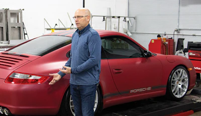 Hagen shows off a vehicle wrapped in red vinyl.