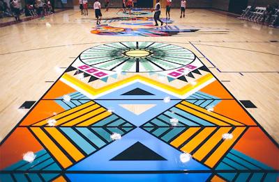 'Art is the tool I use to bring more authentic visual representation and inclusion into existence,' says artist Georgie Nakima, 'so it was equally important for me to add a feminine touch to the mural, which lends a yin and yang dynamic to the court, where the opposing sides still have a complementary form.'