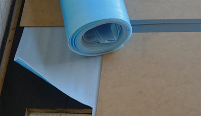 The builders put a plastic/foam combination underlay over the floor after we were done, and they added 4-by-8-foot sheets of 1/8-inch MDF on top to protect the floor. This was different from the brand we had told them to use (and told them where to buy), but we never saw this until we returned to the site weeks later to finish buffing the oil. I was worried about the microenvironment created under all this, but it all turned out fine.