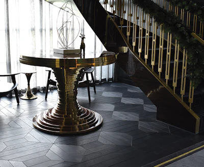 In this small staircase area, there was another custom parquet panel design that was designed to fit the space without any partial cuts. The two bottom photos show the floor after oiling but before the final buffing.