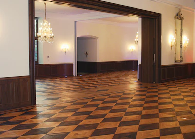 The floor with oil finish after installation (above) and after more recent refinishing with waterborne finish (below).)