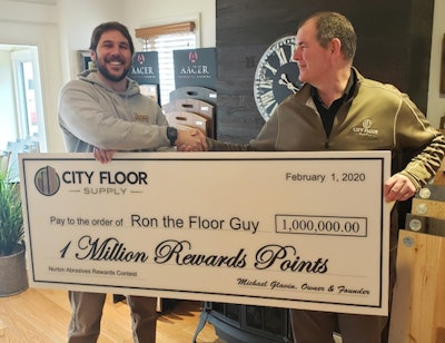 Ron the Floor Guy Owner Dennis Dube Jr. (left) accepting his 1 Million Rewards Points from City Floor Supply Founder Mike Glavin.