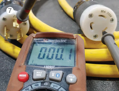 Testing ohms in an extension cord.