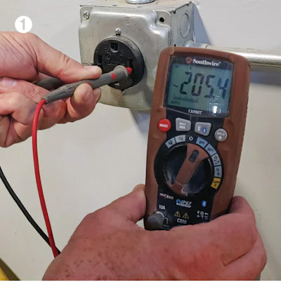 Testing volts in a live outlet.