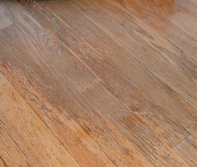 Finish that is completely worn through to bare wood cannot be just recoated.