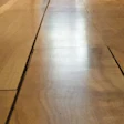 This large gap appeared after the floor dried following a water leak.