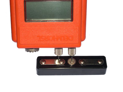 The tool for checking the readings of a pin moisture meter is a moisture content standard.