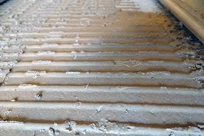 Along some wall lines, the adhesive had not transferred to the flooring.
