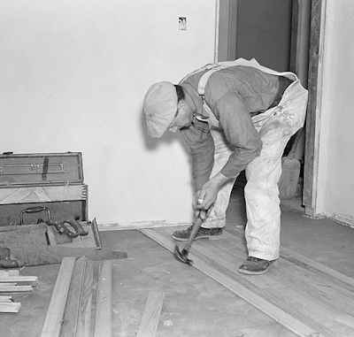 An Ohio floor layer installs a floor using a hammer in 1937. Photo courtesy of the Library of Congress.