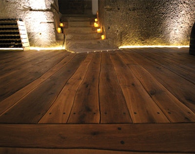 These live-edge planks were painstakingly fit together, then screwed down to a wooden substructure installed over a stone floor.