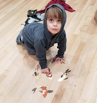 Mark Whatley's son Ronin points to the koi fish that represents him in the family floor.