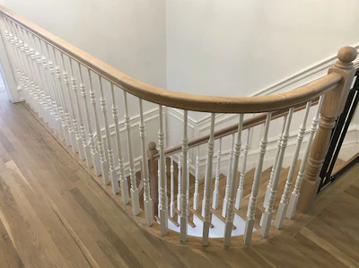 Finished red oak stair handrails and treads, and white oak floor.