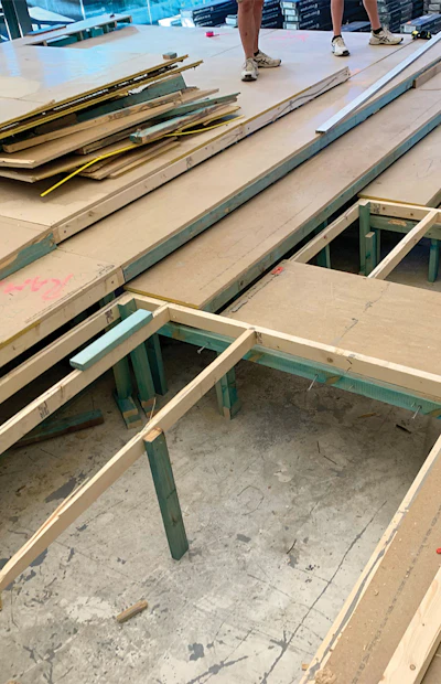 We used lasers to mark the correct straight lines for the entire layout, and I used screws in the substructure to mark, for reference, where our critical points were. Then we went about rebuilding the subfloor structure so it aligned, and we also redid some sections, as you can see above, to make them flat.