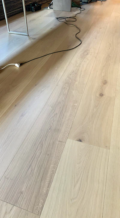 The main floor was laid using 360 mm X 5000 mm boards installed over the yellow tongue subflooring I mentioned earlier. They are nailed down only—no glue—making the flooring removable if trends change.