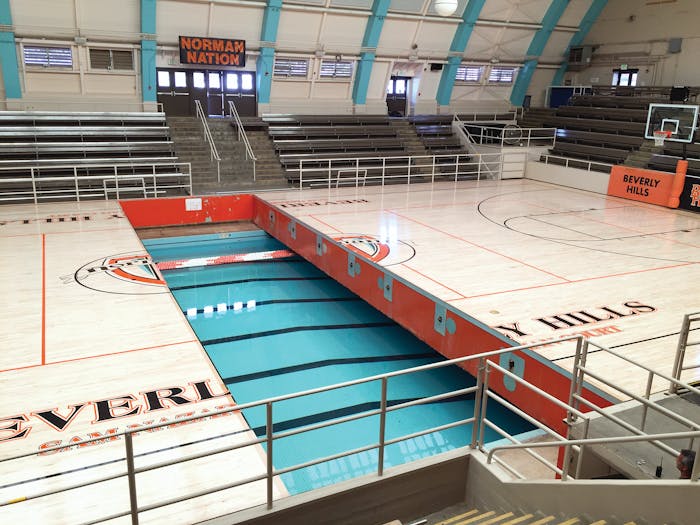 The 'Swim Gym' court retracting underneath the arena's bleachers. (Courtesy Pacific Floor)