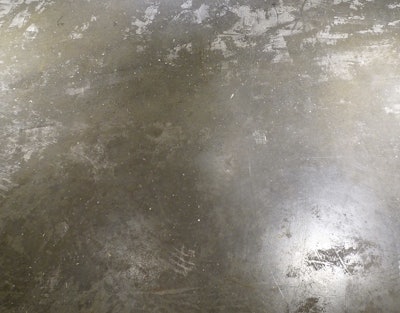 This concrete subfloor was too smooth for the flooring adhesive.