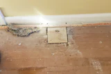 Once you pull carpeting up, you can find complications the homeowners didn’t know about, like this plywood from where a wall was removed.