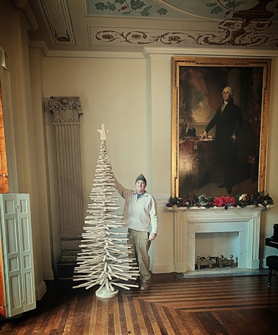 Universal Floor's Sprigg Lynn with the a tree crafted from antique wood flooring scraps at the historic Decatur House, where Universal had previously restored the wood floors.